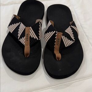 Reef Black Sandal with Black and Cream Patterned Straps and Brown Accent